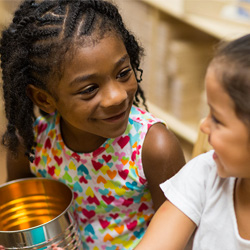 Preschool children smiling and interacting during classroom learning activity